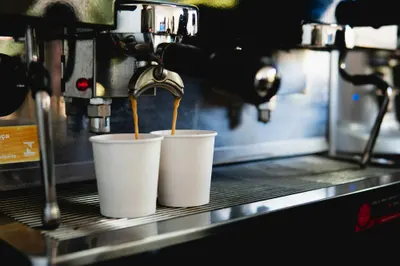 Espresso pouring from the machine into two cups