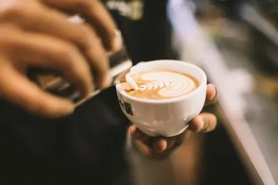 Latte with a rosetta in a white cup